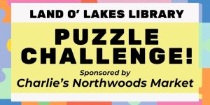 Banner for a Puzzle Challenge at Land O' Lakes Library, sponsored by Charlie’s Northwoods Market.