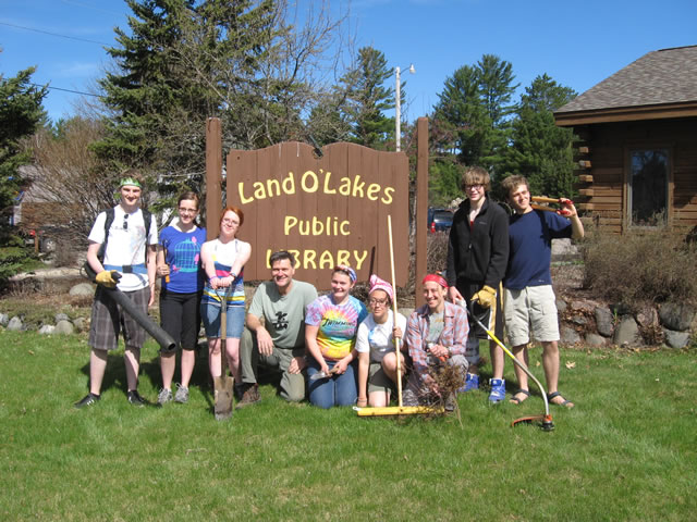 Volunteers and students cleaning up the Land O’ Lakes Public Library garden